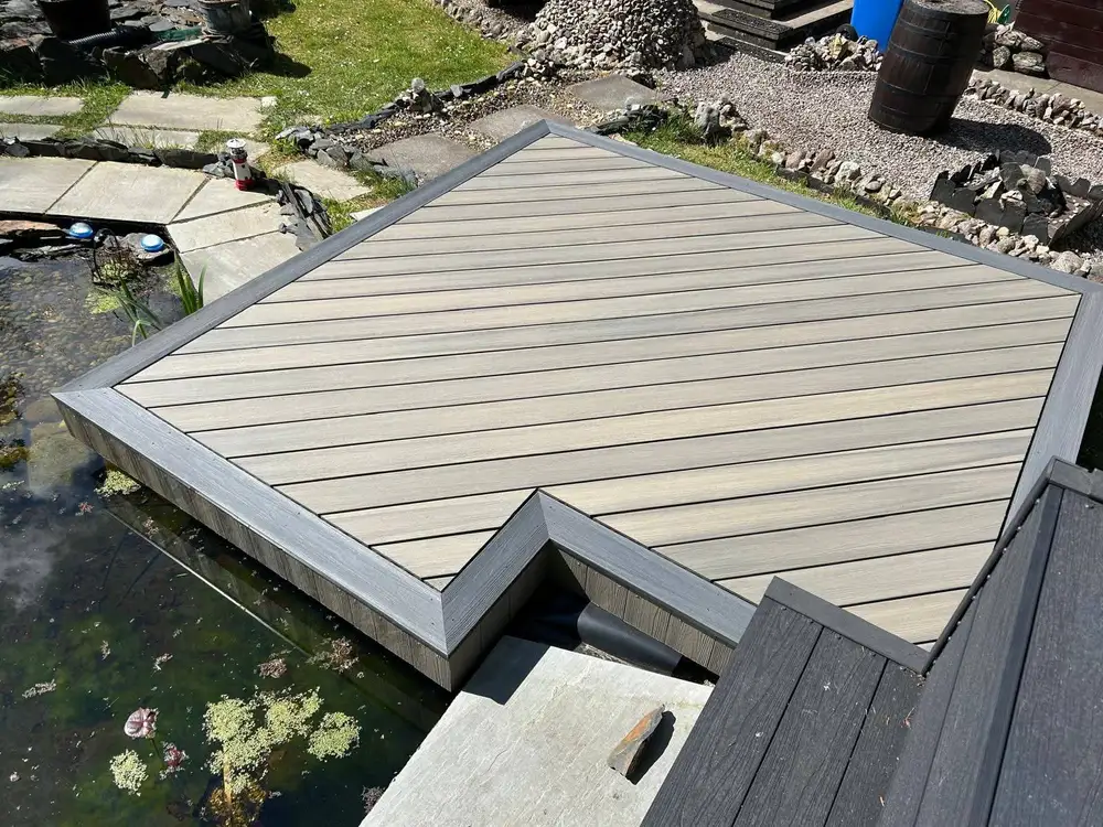 Composite decking platform built over a garden pond by Glasgow Decking Group in Bearsden