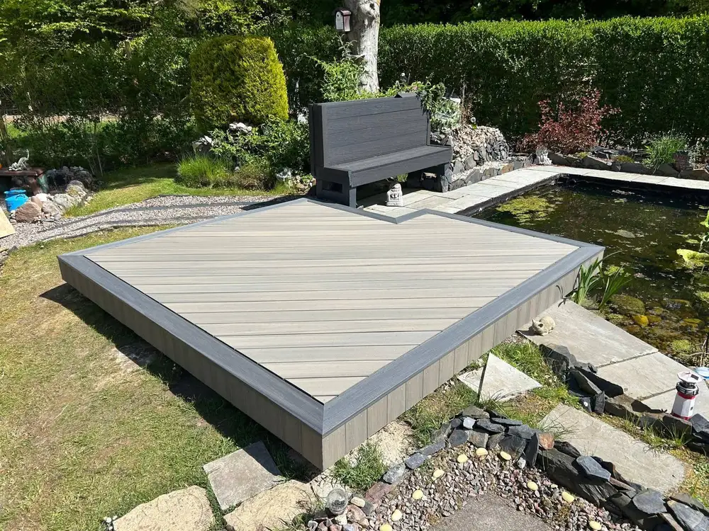 Composite decking with built-in bench seating and planters installed by Glasgow Decking Group in Newton Mearns